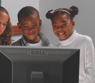 Students looking at computer
